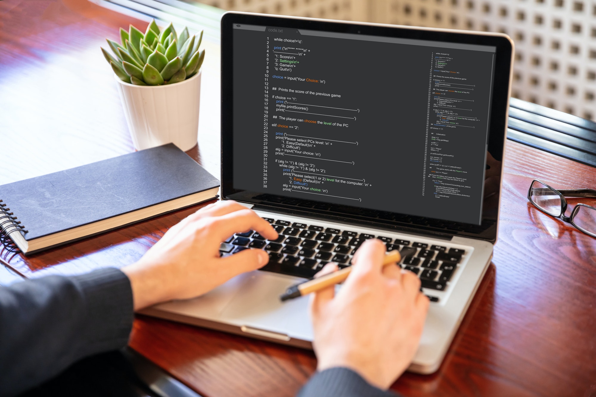 Man programming on a computer, office background